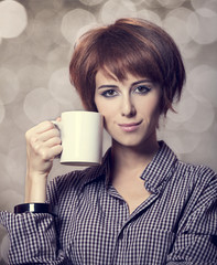 Style girl in shirt with cup at studio.
