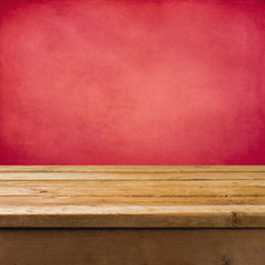 Background with wooden table and pink grunge wall