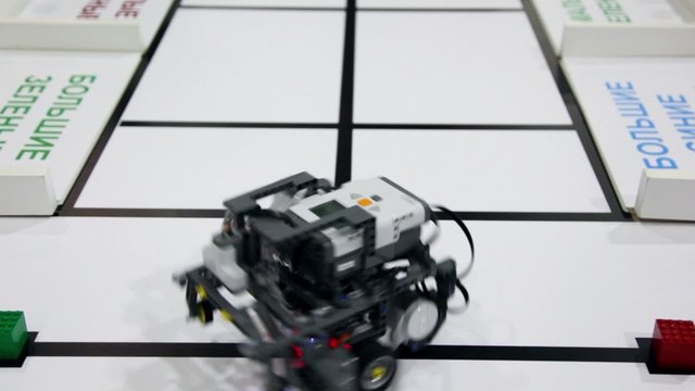 Small robot moves and take green cub