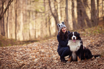 Beautiful Girl with her dog in autumn forest - 47940303