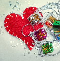Colored and decorated shining gift boxes and red heart