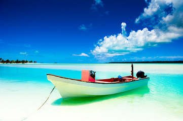 Peaceful calm setting of a boat in a tropical lagoon