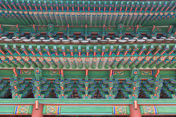 Naklejka premium Decorated woodwork on the roof. Changdeokgung Palace. Seoul