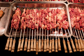 Raw red meat skewers