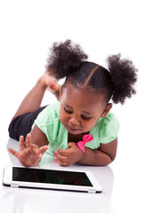 Little african american girl using a tablet pc