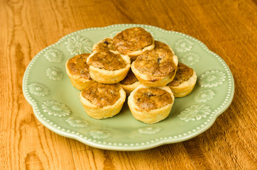 Green plate of pecan tassie cookies
