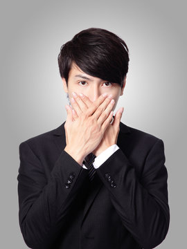 young business man covering his mouth