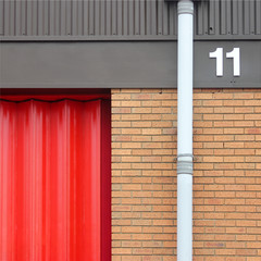 Unit 11 with red shutter, guttering and bricks