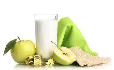 Glass of kefir, green apples, crispbreads and measuring tape