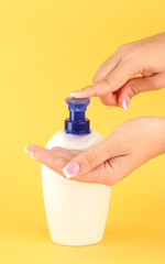 woman squeezing lotion