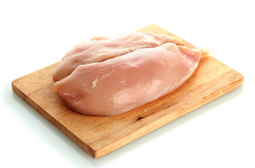 raw chicken meat on cutting board, isolated on white