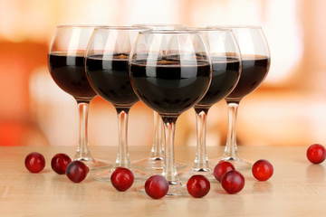 Red wine in glass on room background