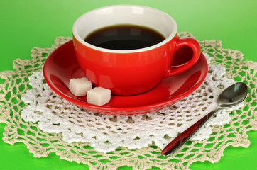 A cup of strong coffee on green background