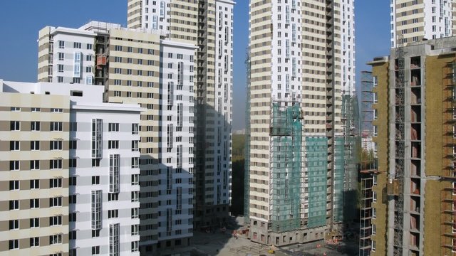 On building site stands many new buildings and go building lifts