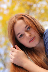 Portrait of a beautiful redhead girl outdoors