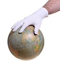 hand with white glove holding globe