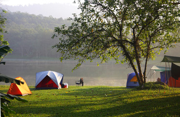 Naklejka premium Tents in recreation area near the reservoir, Thailand.