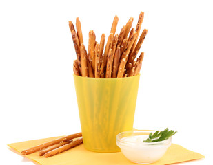 Tasty crispy sticks in yellow plastic cup isolated on white