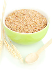 Green bowl full of wheat bran isolated on white