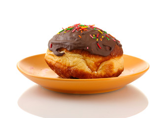 Tasty donut on color plate isolated on white