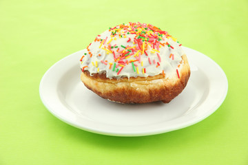 Tasty donuts on color plate on color background