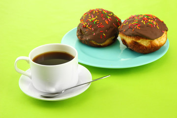 Tasty donuts on color plate on color background