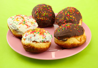 Tasty donuts on color plate on color background