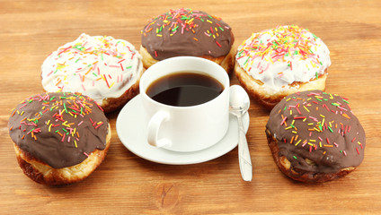 Tasty donuts on color plate on wooden background