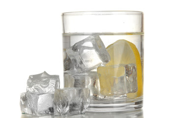 Ice cubes in glass with lemon isolated on white
