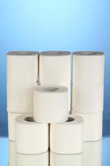 Rolls of toilet paper on blue background