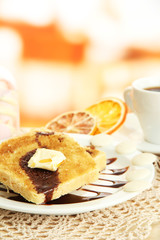 White bread toast with chocolate and cup of coffee in cafe