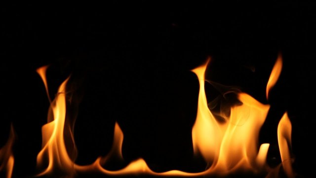 Flaming log with black background.