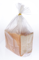 Bread in the plastic bag isolated on white background