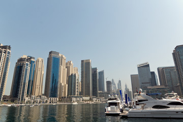 Fototapeta na wymiar Dubai Marina Yacht and Skyscrapers