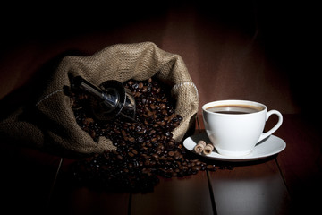 cup of coffee with grains on a dark background
