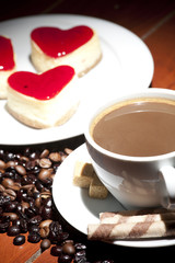 cake  on plate and cup of coffee on wooden table
