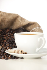 Cup of black coffee and beans isolated on white