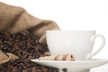 Cup of black coffee and beans isolated on white