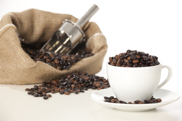 Cup of black coffee and beans isolated on white