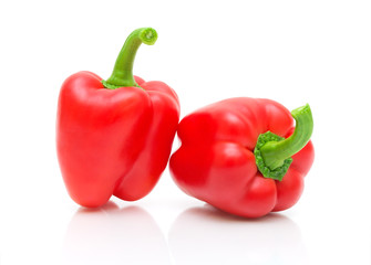 Two red peppers on a white background