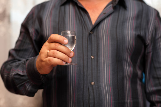 Man holding glass of vodka