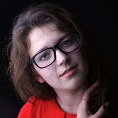 Close-up of a girl in black-rimmed glasses