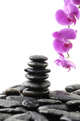 Obraz na płótnie Canvas Zen streszczenie stosu kamieni w równowadze z różowa orchidea
