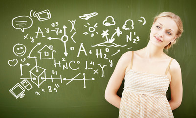 portrait of young teacher near blackboard