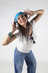 Beautiful dancing girl listening to music with headsets