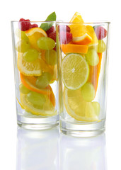 transparent glasses with citrus fruits, isolated on white