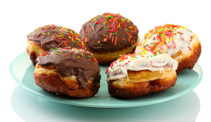 Tasty donuts on color plate isolated on white