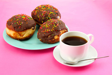 Tasty donuts on color plate on color background