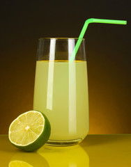 Delicious lemon juice in glass and lime next to it