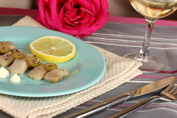 Dish of herring on plate on table close-up
